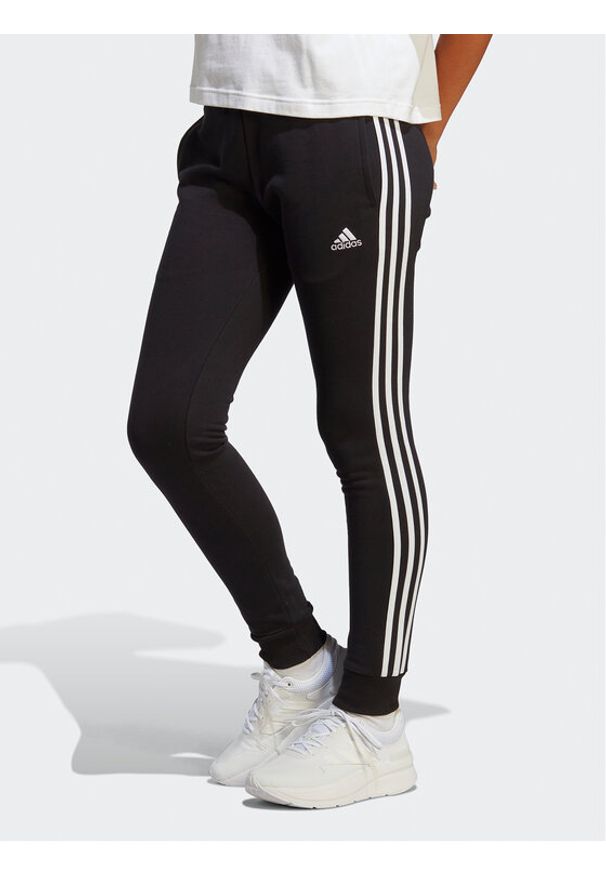 Adidas - adidas Spodnie dresowe Essentials 3-Stripes French Terry Cuffed Joggers IC8770 Czarny Slim Fit. Kolor: czarny. Materiał: bawełna