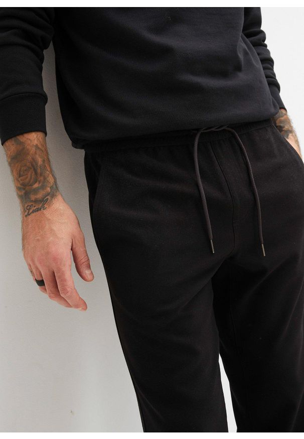 bonprix - Spodnie z gumką w talii, ze stretchem, krój loose fit, straight. Kolor: czarny
