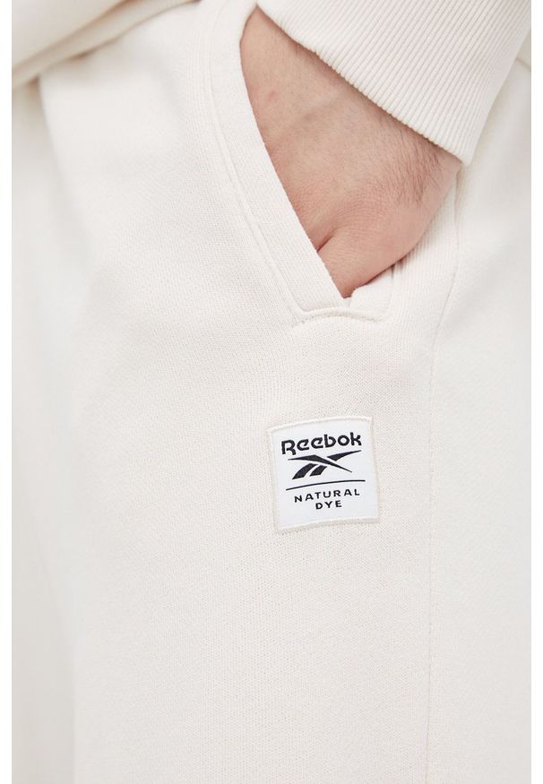 Reebok Classic Spodnie męskie gładkie. Kolor: beżowy. Materiał: bawełna. Wzór: gładki