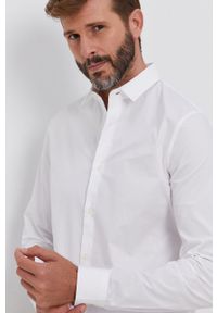 Calvin Klein Jeans Koszula męska kolor biały slim z kołnierzykiem klasycznym. Typ kołnierza: kołnierzyk klasyczny. Kolor: biały. Materiał: tkanina. Długość rękawa: długi rękaw. Długość: długie. Wzór: gładki. Styl: klasyczny