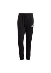 Adidas - Spodnie męskie adidas Essentials Tapered Cuff 3 Stripes. Kolor: biały, czarny, wielokolorowy. Materiał: bawełna, wiskoza, poliester. Wzór: paski. Sport: joga i pilates