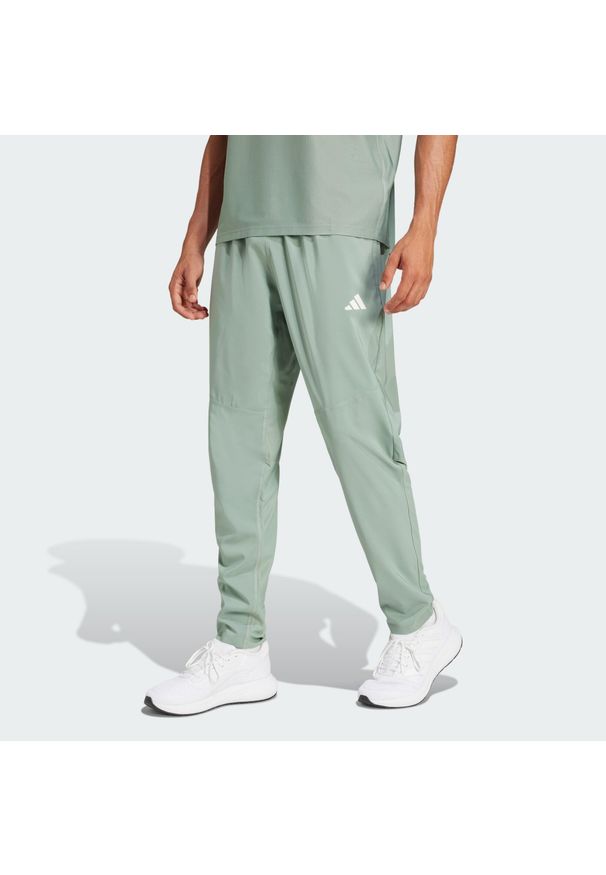Adidas - Spodnie Own The Run. Kolor: zielony. Materiał: materiał. Sport: bieganie