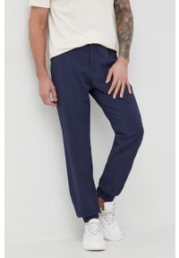 Emporio Armani spodnie wełniane męskie kolor granatowy joggery. Kolor: niebieski. Materiał: wełna