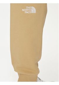 The North Face Spodnie dresowe Nse Light NF0A4T1F Beżowy Regular Fit. Kolor: beżowy. Materiał: bawełna
