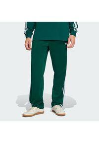 Adidas - adidas Spodnie dresowe Firebird KD8317 Zielony Loose Fit. Kolor: zielony. Materiał: syntetyk #1
