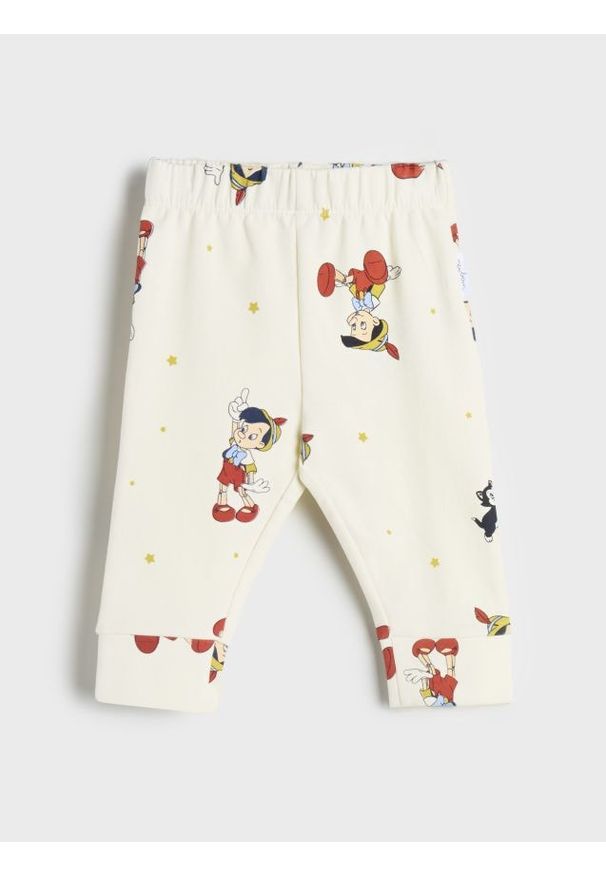 Sinsay - Legginsy Disney - kremowy. Kolor: kremowy. Materiał: elastan, bawełna. Wzór: motyw z bajki