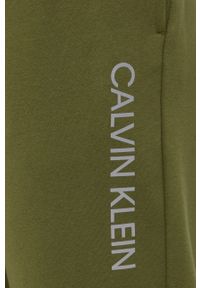 Calvin Klein Performance spodnie męskie kolor zielony z nadrukiem. Kolor: zielony. Wzór: nadruk