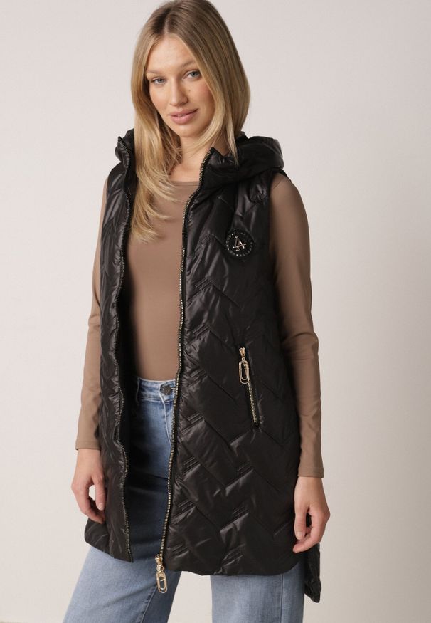 Born2be - Czarna Przejściowa Kamizelka Pikowana o Długim Kroju z Kapturem i Naszywką Harmaste. Okazja: na co dzień. Typ kołnierza: kaptur. Kolor: czarny. Materiał: jeans. Długość: długie. Wzór: aplikacja. Styl: casual