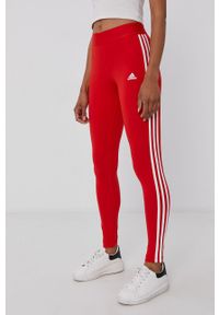 Adidas - adidas Legginsy damskie kolor czerwony gładkie. Kolor: czerwony. Materiał: dzianina, bawełna. Wzór: gładki