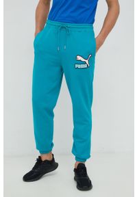 Puma spodnie dresowe bawełniane męskie kolor turkusowy z aplikacją. Kolor: turkusowy. Materiał: bawełna, dresówka. Wzór: aplikacja #1