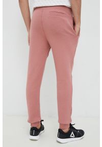 Guess spodnie dresowe kolor różowy melanżowe. Kolor: różowy. Materiał: dresówka. Wzór: melanż #4