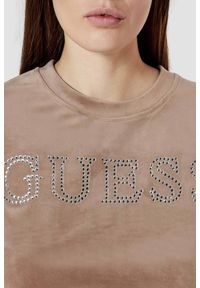 Guess - GUESS Brązowy damski top Couture Tee. Kolor: brązowy