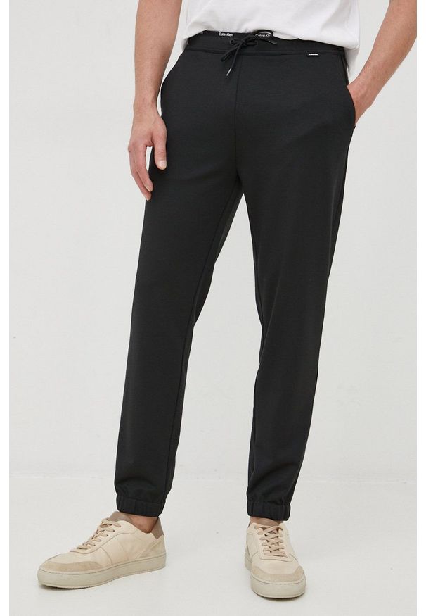 Calvin Klein spodnie dresowe męskie kolor czarny gładkie. Kolor: czarny. Materiał: dresówka. Wzór: gładki