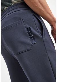 Armani Exchange - Spodnie dresowe ARMANI EXCHANGE. Materiał: dresówka. Wzór: aplikacja