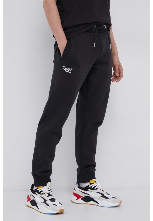 Superdry Spodnie męskie kolor czarny gładkie. Kolor: czarny. Materiał: dzianina. Wzór: gładki