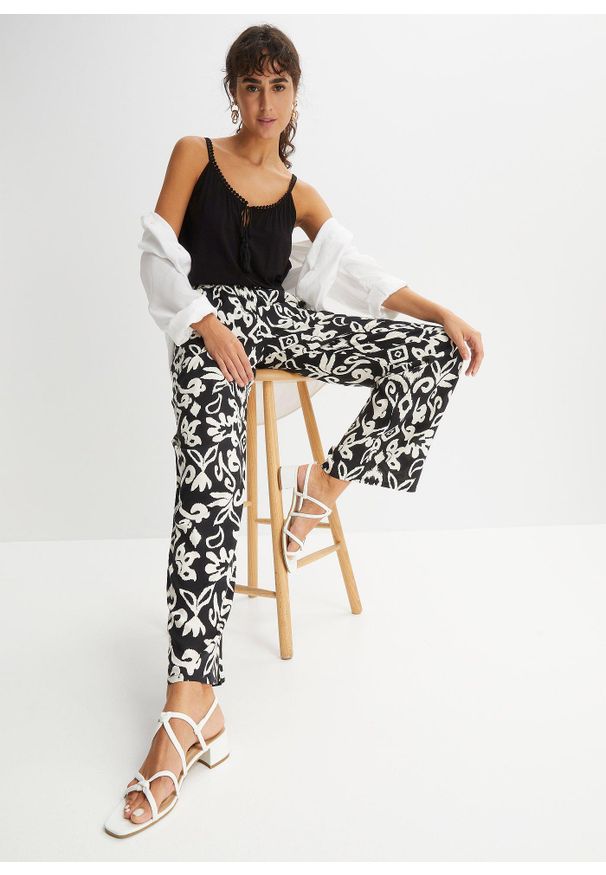 bonprix - Spodnie Marlena z lejącej wiskozy. Kolor: czarny. Materiał: wiskoza. Wzór: nadruk