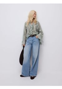 Reserved - Jeansy baggy fit - turkusowy. Kolor: turkusowy
