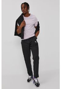 Puma Spodnie męskie kolor czarny gładkie. Kolor: czarny. Materiał: materiał, tkanina. Wzór: gładki