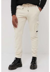 Jack & Jones spodnie męskie kolor beżowy gładkie. Kolor: beżowy. Materiał: dzianina. Wzór: gładki