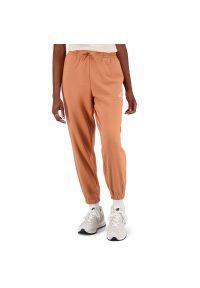 Spodnie New Balance WP31508SEI - pomarańczowe. Kolor: pomarańczowy. Materiał: poliester, dresówka, bawełna