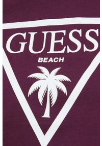 Guess t-shirt bawełniany kolor fioletowy. Kolor: fioletowy. Materiał: bawełna. Długość rękawa: krótki rękaw. Długość: krótkie. Wzór: nadruk #2