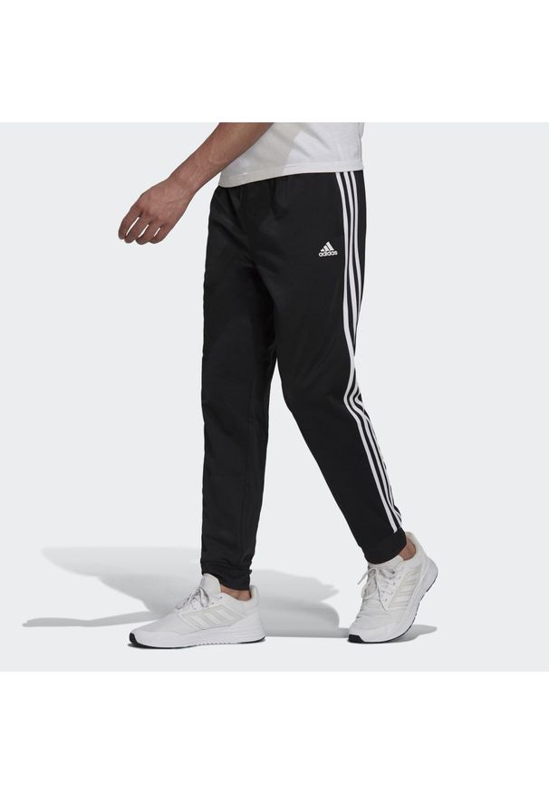 Adidas - Spodnie męskie adidas Primegreen Essentials Warm-Up Tapered 3-Stripes Track. Kolor: czarny, biały, wielokolorowy. Materiał: dresówka, poliester, materiał. Sport: fitness