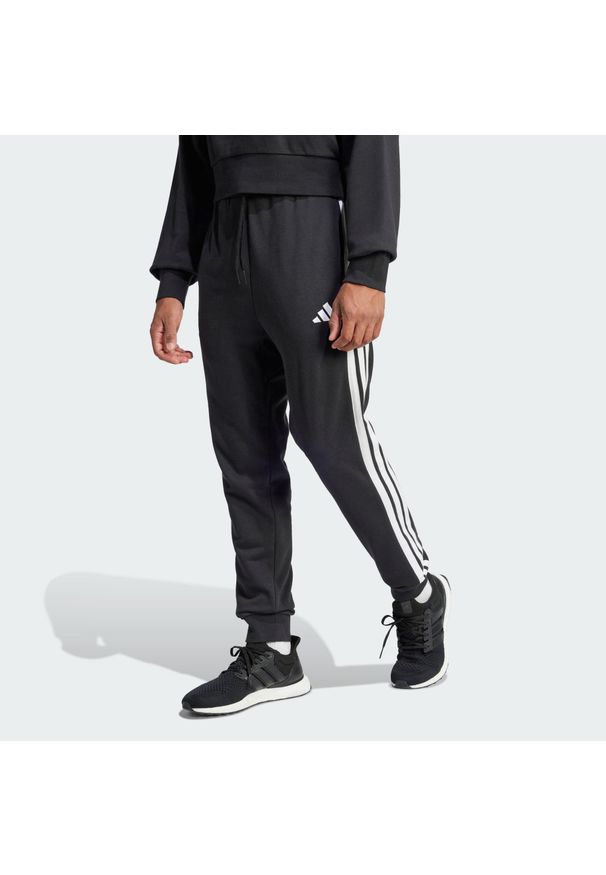 Adidas - Spodnie Essential 3-Stripes French Terry. Kolor: biały, wielokolorowy, czarny. Materiał: materiał