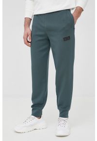 Armani Exchange spodnie męskie kolor zielony gładkie. Kolor: zielony. Materiał: dzianina. Wzór: gładki