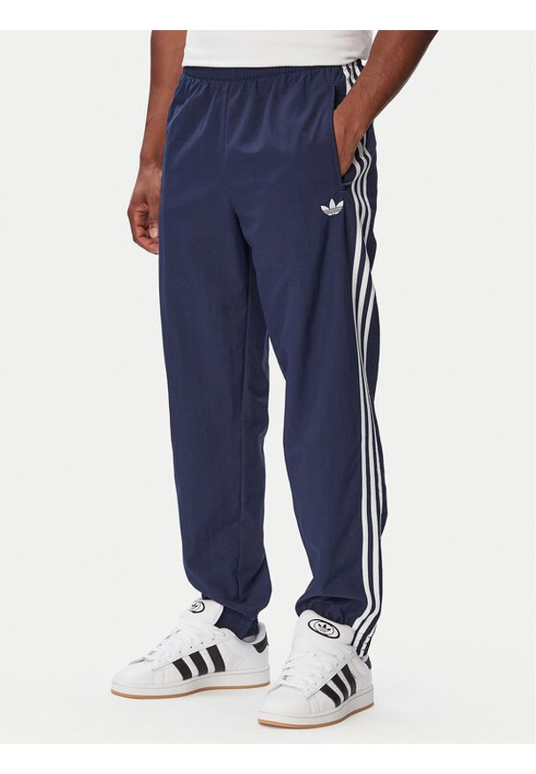Adidas - adidas Spodnie dresowe Firebird Woven KE1370 Granatowy Regular Fit. Kolor: niebieski. Materiał: syntetyk