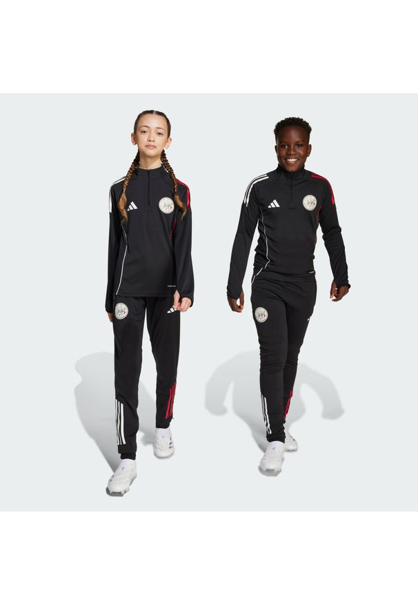 Adidas - Spodnie treningowe dla dzieci Ajax Amsterdam Tiro 25 Competition. Kolor: czerwony, czarny, wielokolorowy, biały. Sport: fitness, piłka nożna