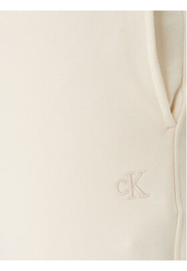 Calvin Klein Jeans Spodnie dresowe Monogram LV047F210G Beżowy Regular Fit. Kolor: beżowy. Materiał: bawełna