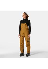 Damskie spodnie narciarskie na szelkach Helly Hansen Powderqueen. Kolor: brązowy. Sezon: zima. Sport: narciarstwo