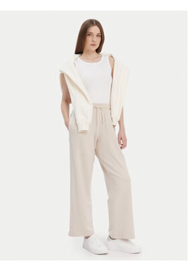 TOMMY HILFIGER - Tommy Hilfiger Spodnie dresowe UW0UW04771 Beżowy Relaxed Fit. Kolor: beżowy. Materiał: dresówka