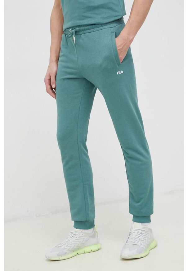 Fila spodnie dresowe kolor zielony gładkie. Kolor: zielony. Materiał: dresówka. Wzór: gładki