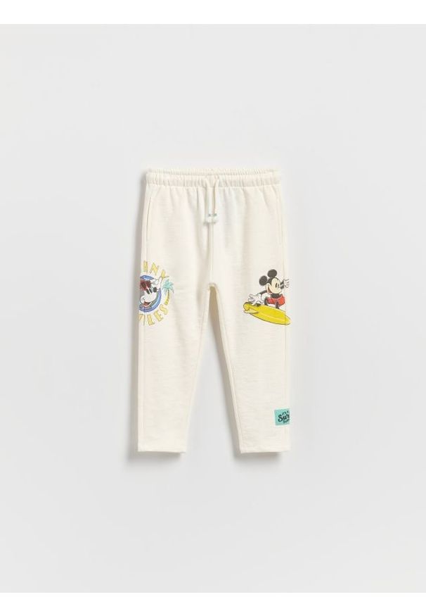 Reserved - Spodnie Mickey Mouse - złamana biel. Materiał: bawełna, dzianina. Wzór: motyw z bajki
