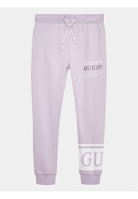 Guess Spodnie dresowe J3YQ11 KA6R4 Fioletowy Relaxed Fit. Kolor: fioletowy. Materiał: bawełna #1