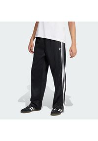 Adidas - adidas Spodnie dresowe adicolor KE3501 Czarny Loose Fit. Kolor: czarny. Materiał: bawełna #1