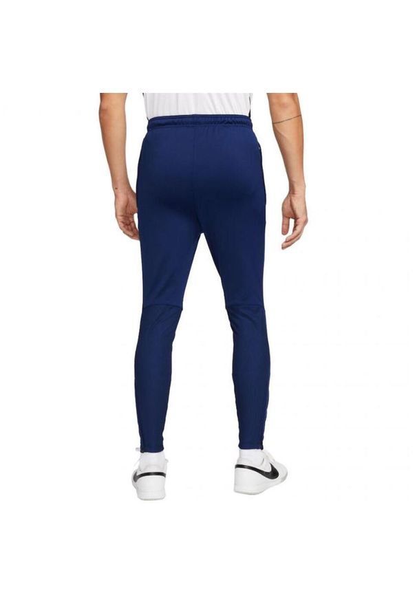 Nike - Męskie Spodnie Do Biegania ThermaFit Strike. Kolor: niebieski