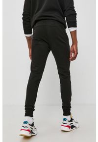 Puma Spodnie 586749 męskie kolor czarny z nadrukiem. Kolor: czarny. Materiał: dzianina. Wzór: nadruk #2