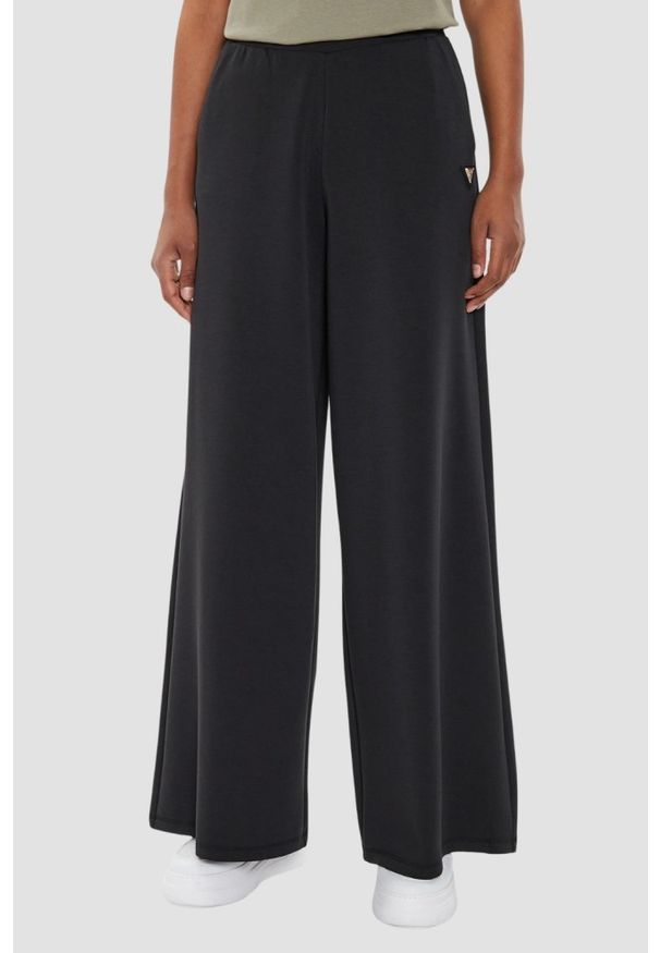 Guess - GUESS Czarne damskie spodnie dresowe Olympe Wide Leg, Rozmiar S. Kolor: czarny. Materiał: dresówka