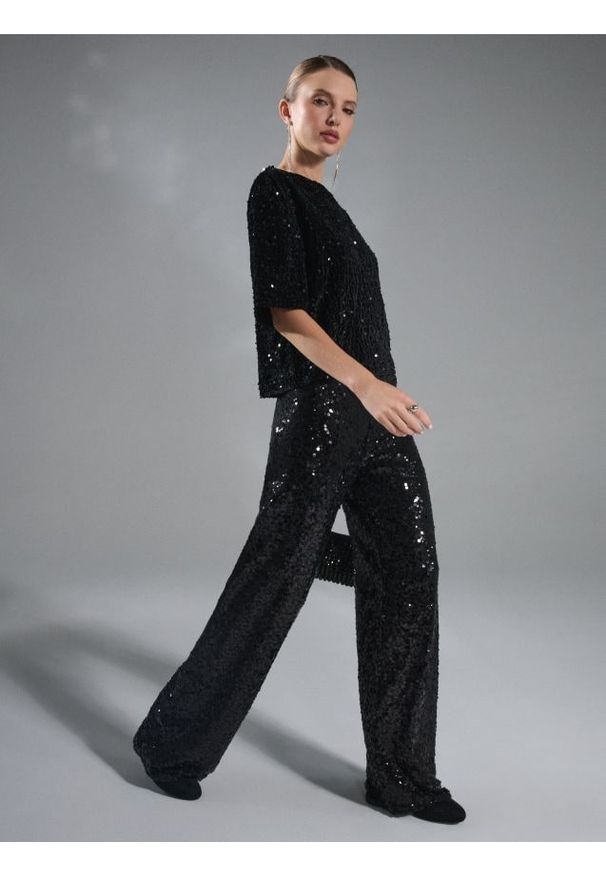 Sinsay - Spodnie wide leg z błyszczącymi cekinami - czarny. Kolor: czarny