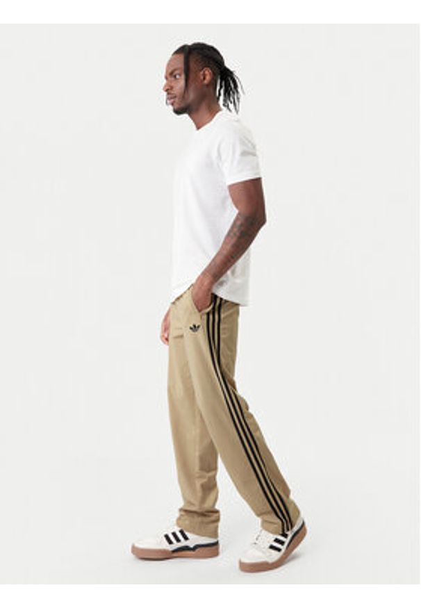 Adidas - adidas Spodnie dresowe Firebird KE6679 Beżowy Loose Fit. Kolor: beżowy. Materiał: syntetyk