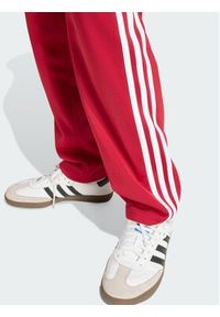 Adidas - adidas Spodnie dresowe Firebird HZ6651 Czerwony Regular Fit. Kolor: czerwony. Materiał: syntetyk #2