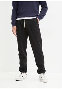 bonprix - Spodnie sportowe z czystej bawełny organicznej. Stan: obniżony. Kolor: czarny. Materiał: bawełna, dresówka. Styl: sportowy #1
