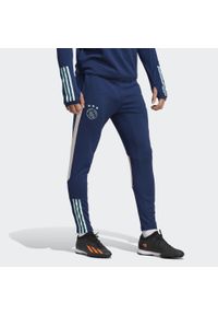 Spodnie do piłki nożej męskie Adidas Ajax Amsterdam Tiro 23 Training Pants. Kolor: wielokolorowy, zielony, niebieski. Materiał: materiał
