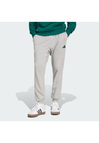 Adidas - Spodnie Essentials Feel Cozy French Terry. Kolor: czarny, szary, wielokolorowy. Materiał: materiał, dresówka. Sport: fitness #1