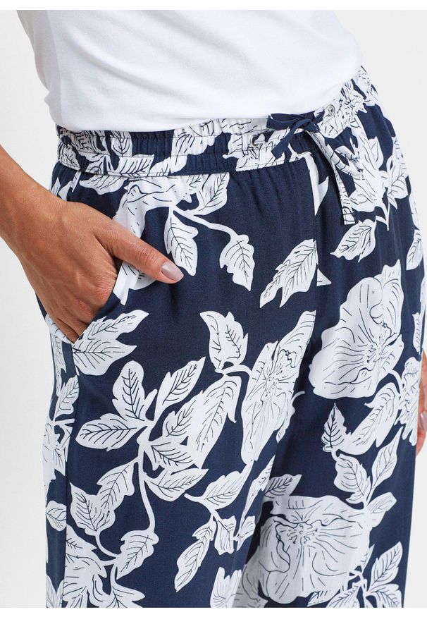bonprix - Spodnie palazzo z lejącej wiskozy. Kolor: czarny. Materiał: wiskoza. Wzór: nadruk. Styl: elegancki