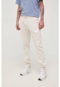 Jack & Jones spodnie męskie kolor beżowy z nadrukiem. Kolor: beżowy. Materiał: dzianina. Wzór: nadruk