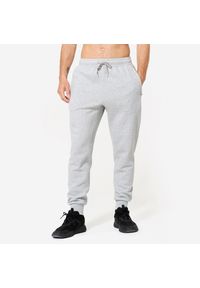 DOMYOS - Spodnie fitness męskie Domyos Gym & Pilates slim. Kolor: szary. Materiał: dresówka, materiał, dzianina. Wzór: ze splotem. Sport: joga i pilates, fitness