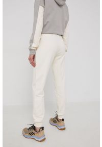 Jack Wolfskin spodnie dresowe damskie kolor beżowy gładkie. Stan: podwyższony. Kolor: beżowy. Materiał: dresówka. Wzór: gładki